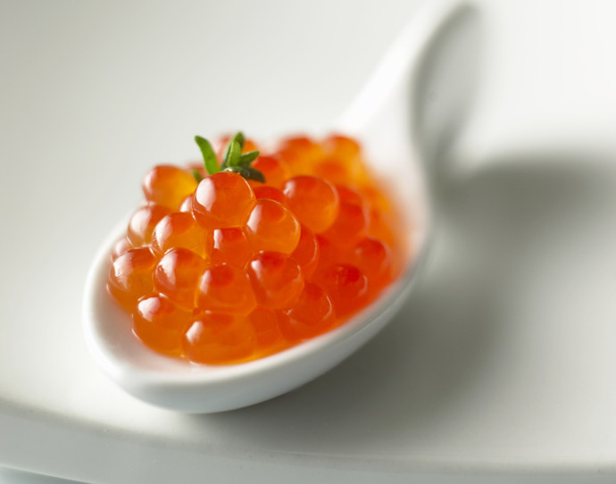 Salmon caviar on spoon, close-up