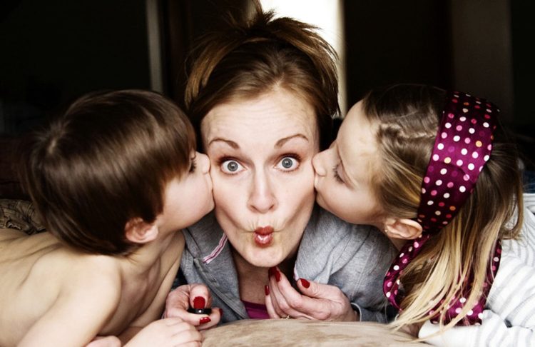 Mom with puckered lips being kissed by kids ~PhotograTree~ Photo URL : http://www.flickr.com/photos/lightfalling/2261753548/