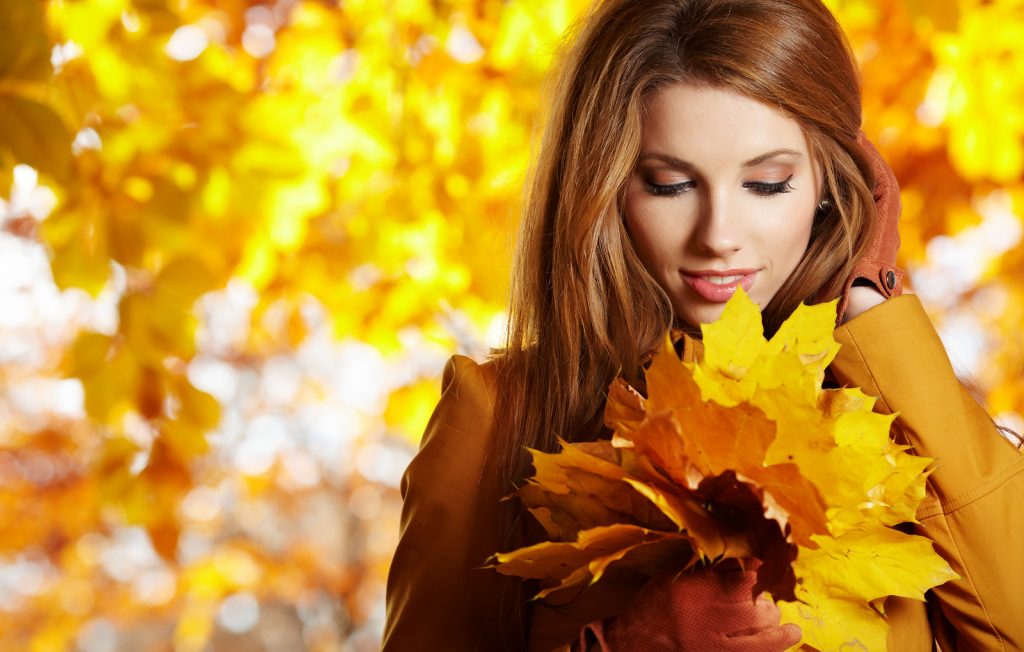 bigstock-young-woman-with-autumn-leaves-25084727