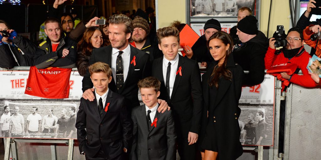 Former Manchester United and England footballer David Beckham, his wife Victoria, and their sons Brooklyn, Romeo and Cruz, pose for pictures at the world premiere of the documentary 'The Class of 92', in London's Leicester Square, on December 1, 2013. AFP PHOTO / LEON NEAL (Photo credit should read LEON NEAL/AFP/Getty Images)