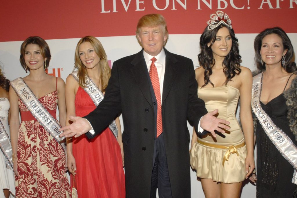 Donald Trump with former Miss Universes and the current Miss Universe, Natalie Glebova (Photo by G. Gershoff/WireImage)