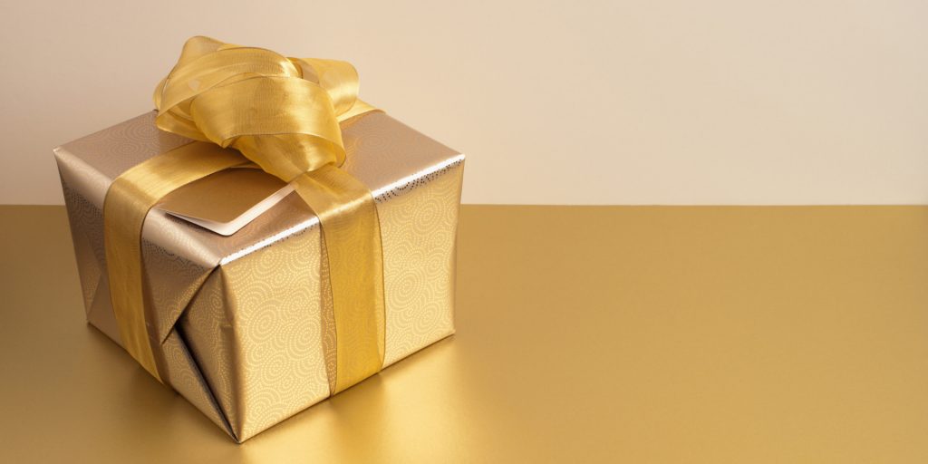 Christmas gift with gold ribbon and gold wrapping